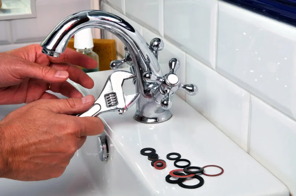 Plumber performing maintenance on a bathroom faucet in Upland