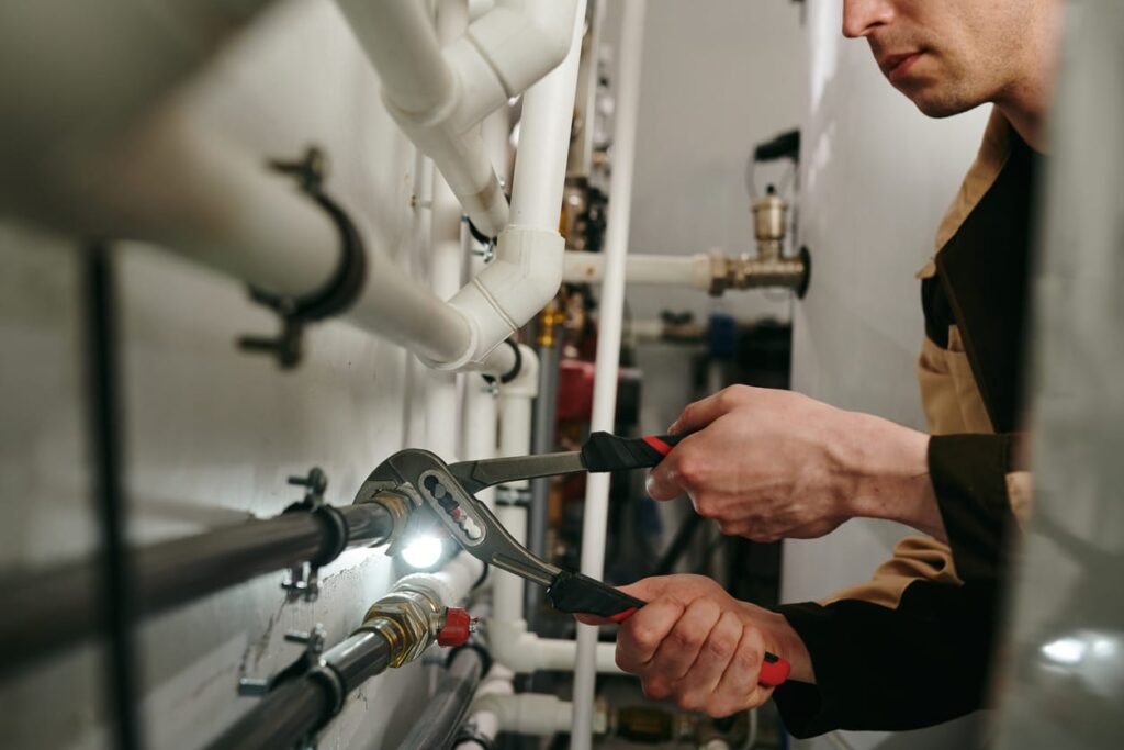 Plumbers maintaining commercial plumbing pipes in Upland