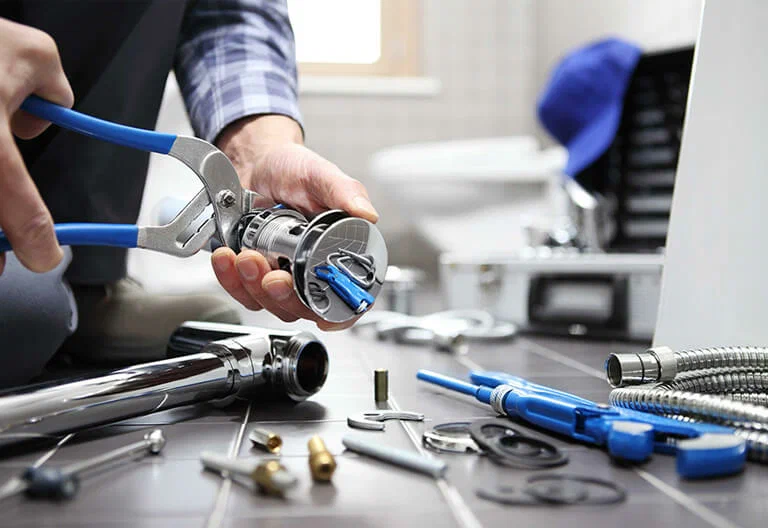 Technician repairing a plumbing fixture with professional tools in Upland