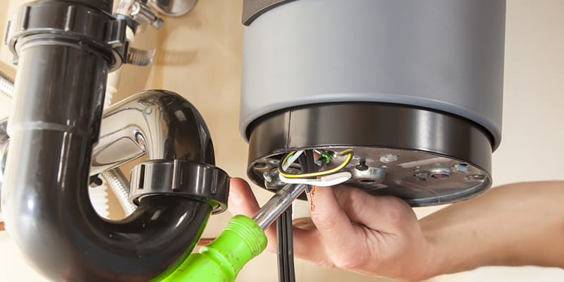 Technician repairing the heating element of a water heater in Upland
