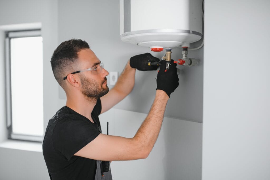 Technician performing water heater maintenance in Upland