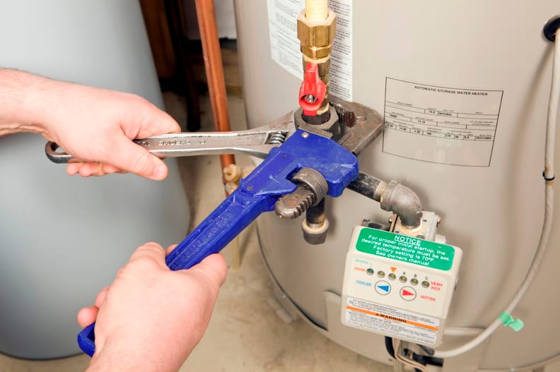 Plumber repairing a water heater valve in Upland